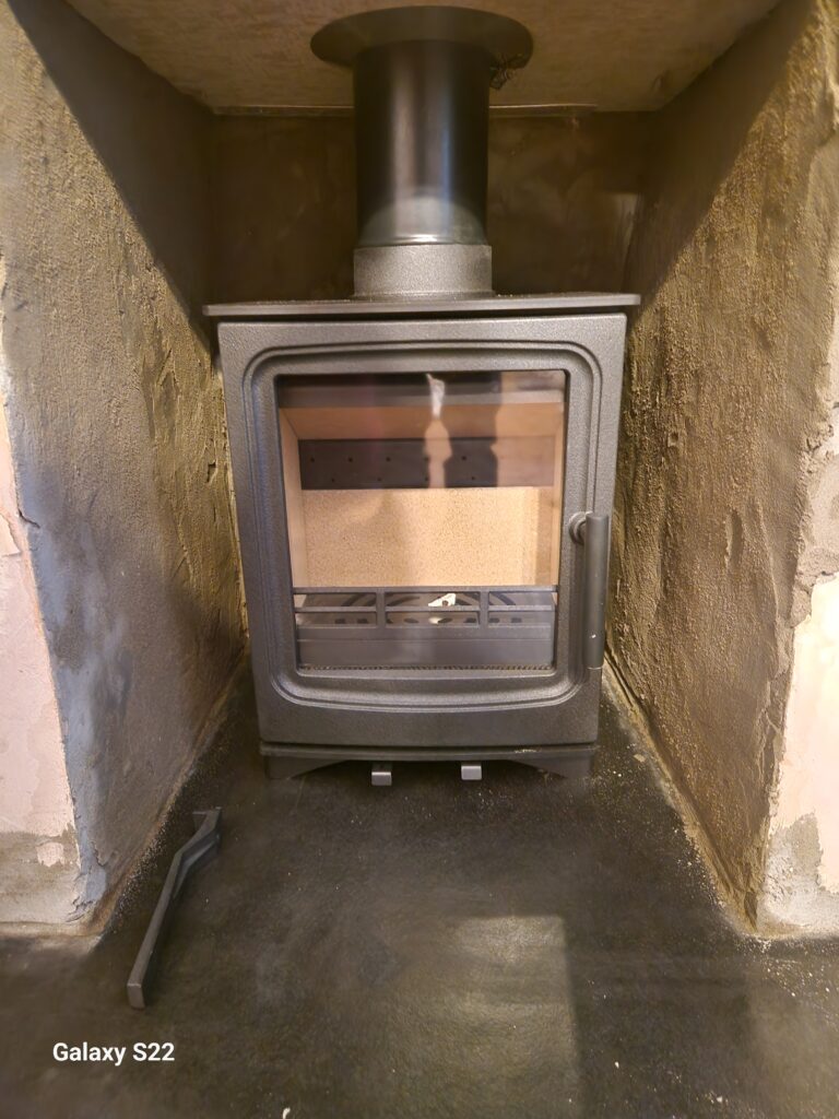 Image of Stove Buddy Classic 4 KW Multifuel Stove Installation in Pontardawe in fireplace recess by premier Log and Multifuel Stove installers Hopkins Log Burners