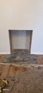 Back of fireplace recess fitted with board alongside new hearth for Mifire Tinderbox large stove Grovesend, Swansea Hopkins Log Burners