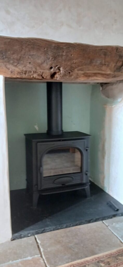 Angled view of Stovax Stockton 8 Multifuel Wood Burning Stove Installation in farmhouse Llandeilo Fan, Sennybridge, Breconshire- Hopkins Log Burners