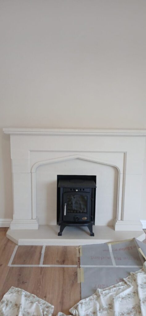 Clarke Wicklow 4.2KW multifuel stove installation in elegant white fireplace surround by Hopkins Log Burners in Cimla property