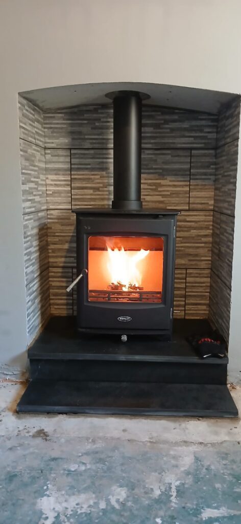 Henley Lincoln 5KW wood burning stove installed by Hopkins Log Burners in Bonymaen, Swansea, featuring modern tiled surround and slate hearth