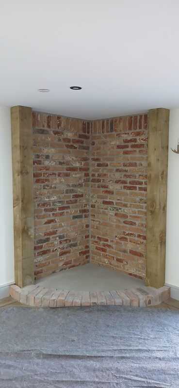 Purpose-built brick corner with curved hearth prepared for F2 Accona Slider installation by Hopkins Log Burners in Bynea, Llanelli