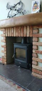 Hopkins Log Burners installed Henley Glenwood multifuel stove in Clydach home - close-up view showing brick slip detailing and slate hearth
