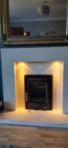 Professional multifuel stove installation in Pontardawe by Hopkins Log Burners featuring Mazona Portway stove with ambient lighting in blue living room