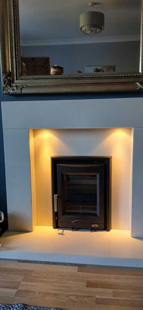 Professional multifuel stove installation in Pontardawe by Hopkins Log Burners featuring Mazona Portway stove with ambient lighting in blue living room